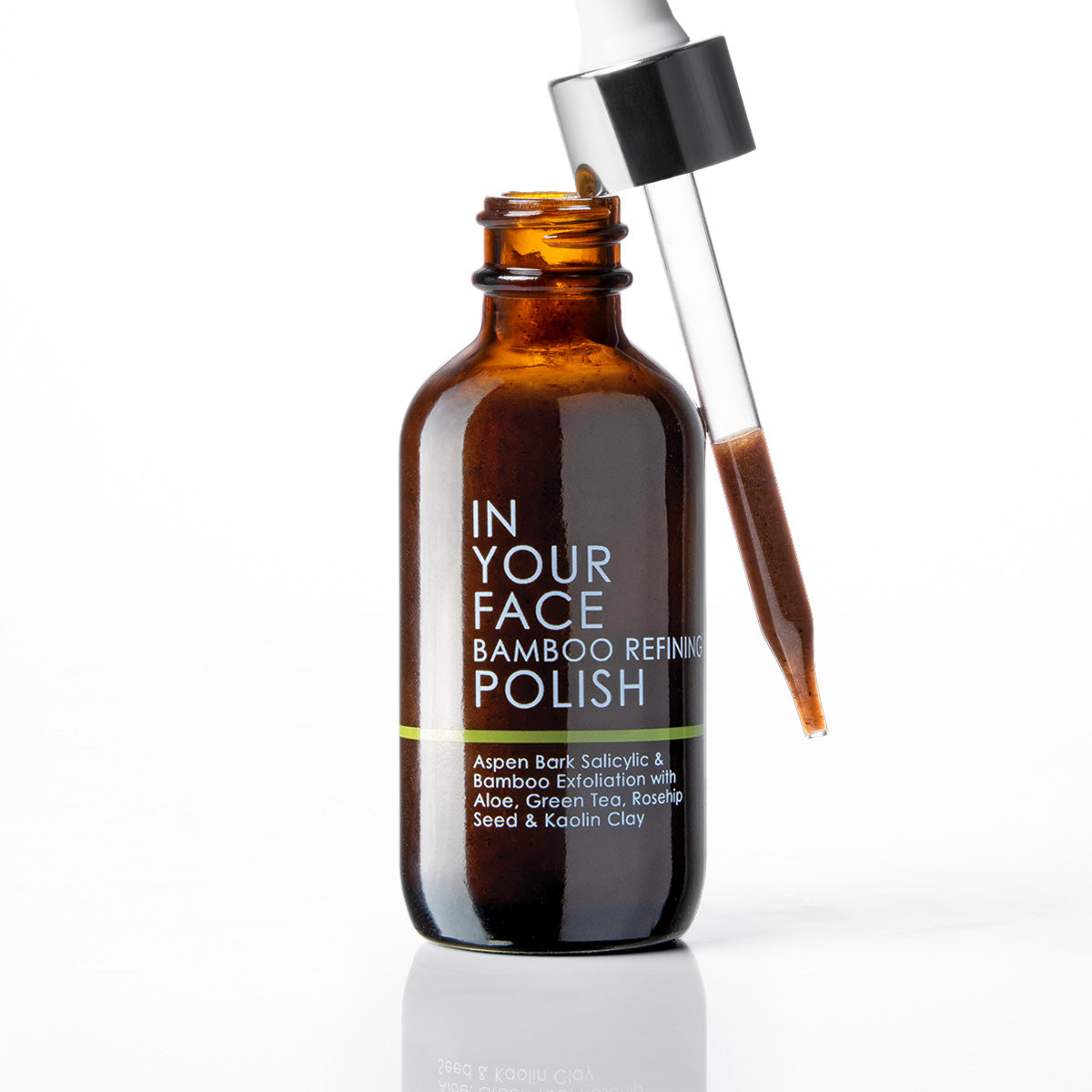 An amber glass bottle of IN YOUR FACE BAMBOO REFINING POLISH with a glass dropper containing brown liquid, set against a clean white background.