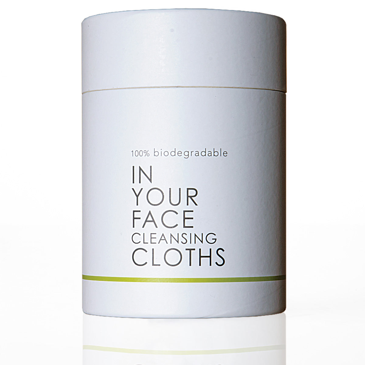 A white cylindrical container of 'In Your Face Cleansing Cloths' with black text and a thin green stripe, set against a plain white background with a subtle reflection.