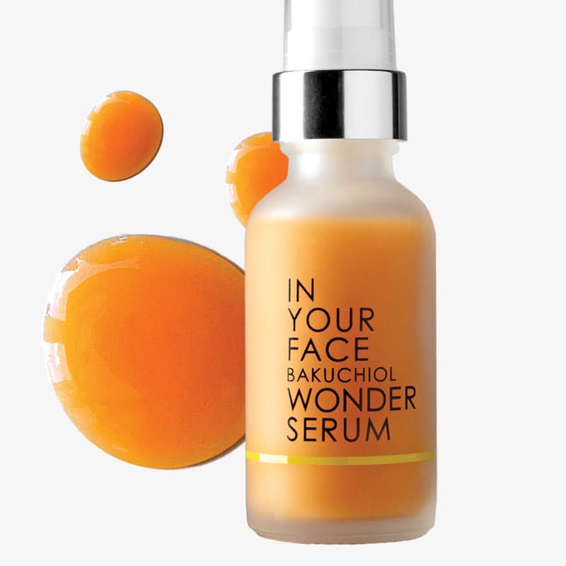 Bottle of 'In Your Face Bakuchiol Wonder Serum' with product drops on a white background