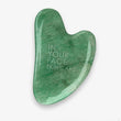 Green stone gua sha tool with 'In Your Face Skincare' text on a white background