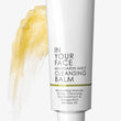 Cleansing balm tube with yellow cream on a white background