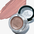 Cosmetic cream in a jar with a swatch of color next to it, branded 'In Your Face Skincare'.
