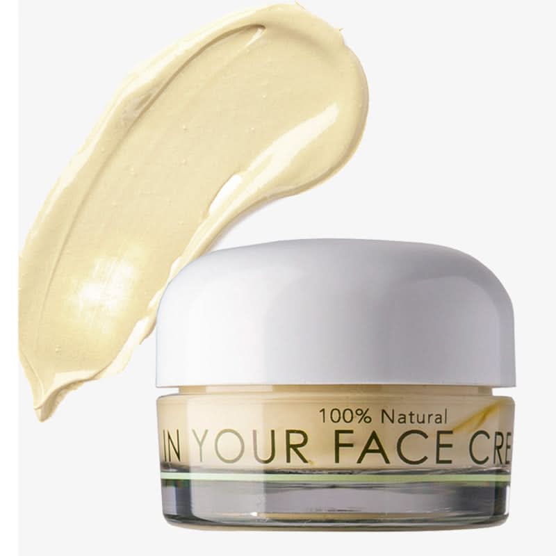 Jar of 'In Your Face Cream' with a swatch of cream on a white background