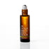 An amber glass rollerball bottle with a white cap, labeled 'IN YOUR FACE CITRUS SOLEIL' by Aromatherapy, set against a clean white background with a soft reflection.