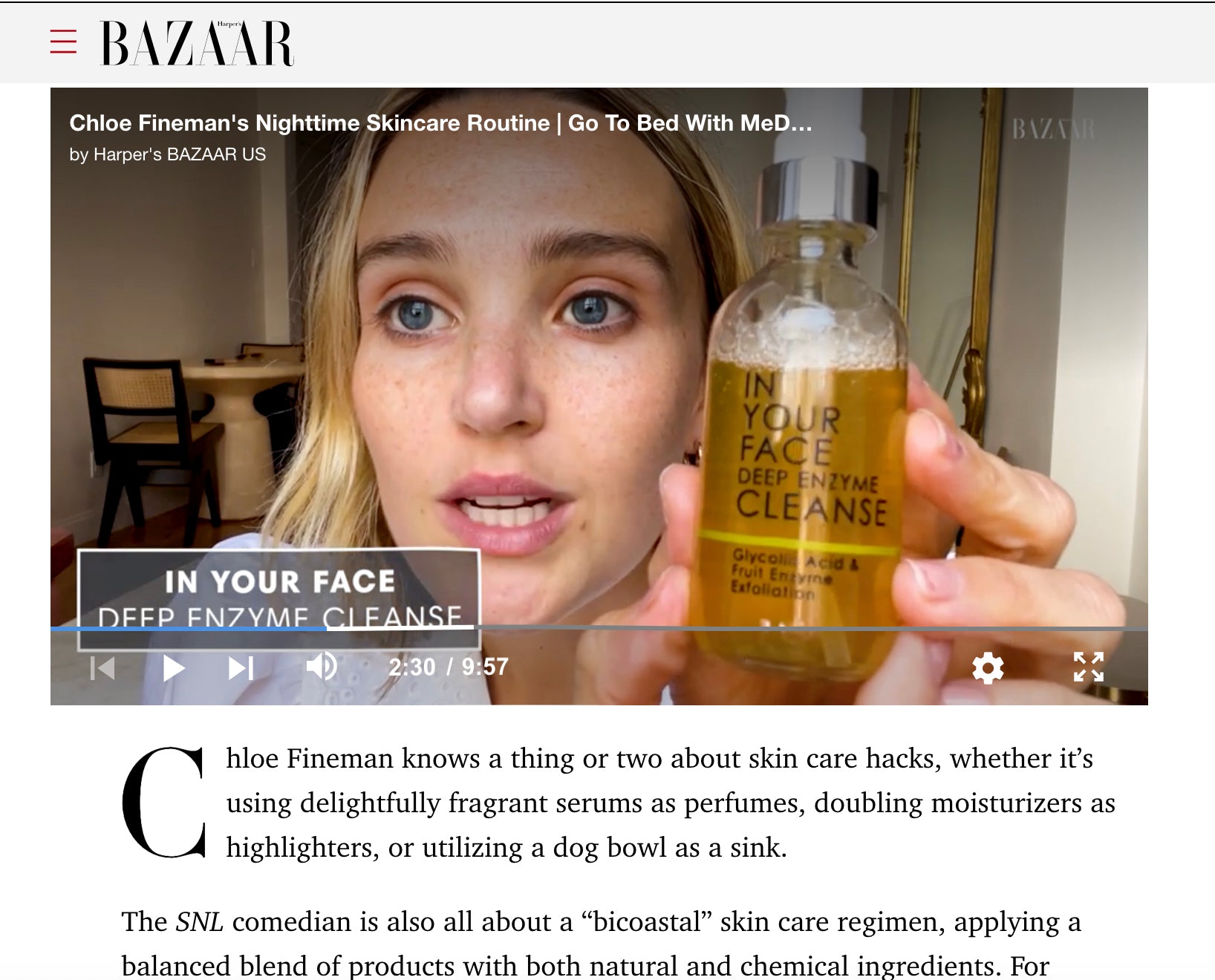 Person holding a skincare product with a video player interface overlay on Harper's BAZAAR website.