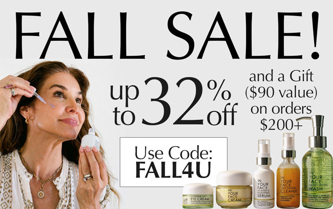 Promotional sale graphic with a woman applying skincare cream to her face, large text reading 'FALL SALE!' and 'up to 32% off', a gift offer, and several skincare bottles and jars shown along the bottom on a white background.