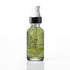 A clear glass bottle of 'In Your Face Moisturizing Wash' filled with green gel and suspended bubbles, featuring a black collar and white pump dispenser, set against a clean white background with a soft reflection.