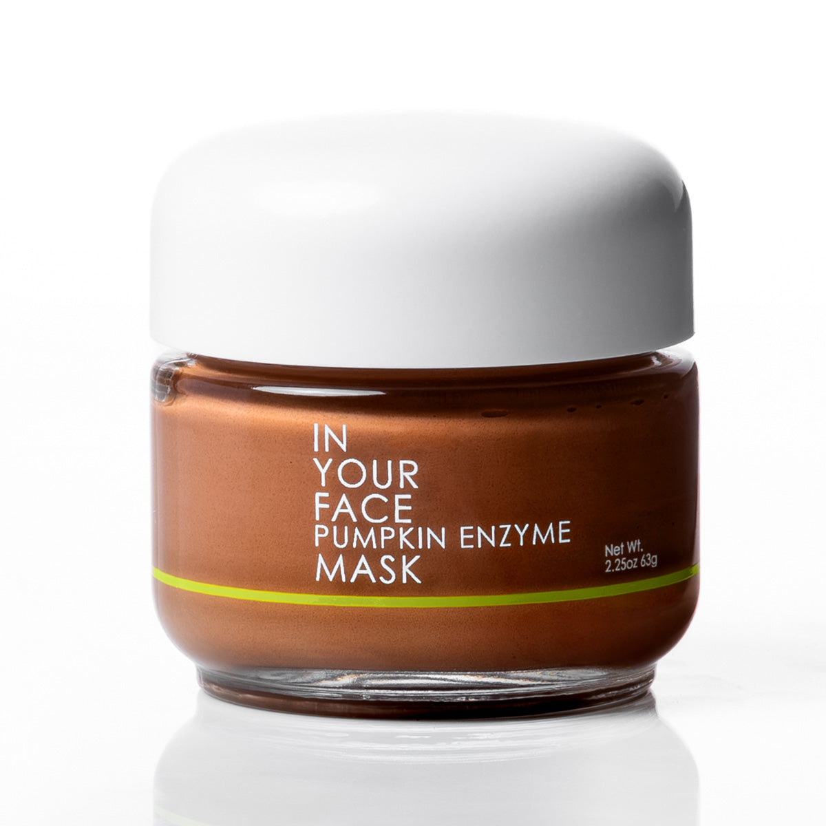 A jar of In Your Face Pumpkin Enzyme Mask with a white lid and a brown body, set against a clean white background with a soft reflection.