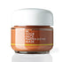 A jar of In Your Face Pumpkin Enzyme Mask with a white lid and a brownish-orange mask visible through the clear glass jar, set against a white background with a soft reflection.
