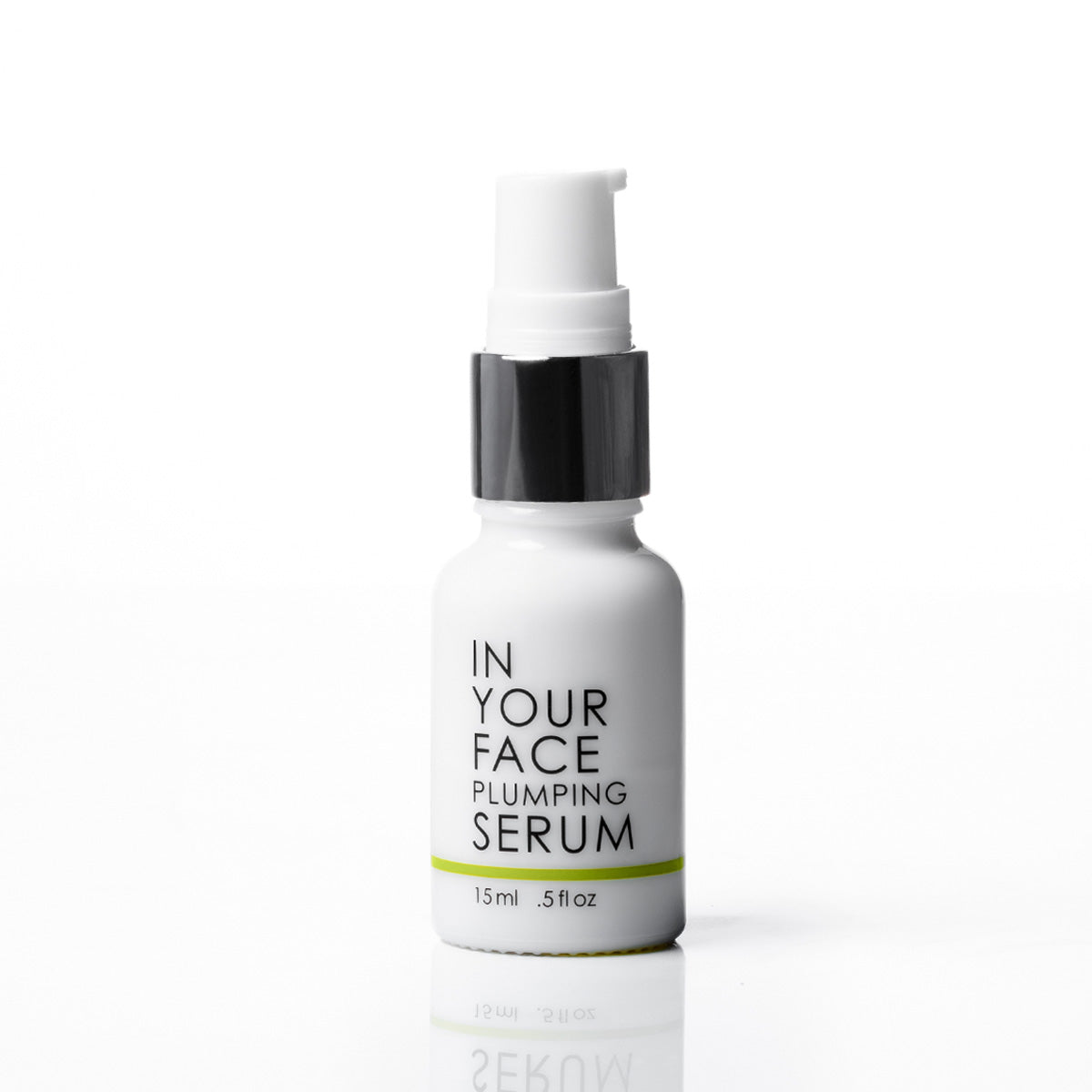 A white pump bottle of IN YOUR FACE PLUMPING SERUM with a black collar and white cap, set against a clean white background with a soft reflection below.