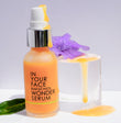 BAKUCHIOL WONDER SERUM with texture and purple flower.