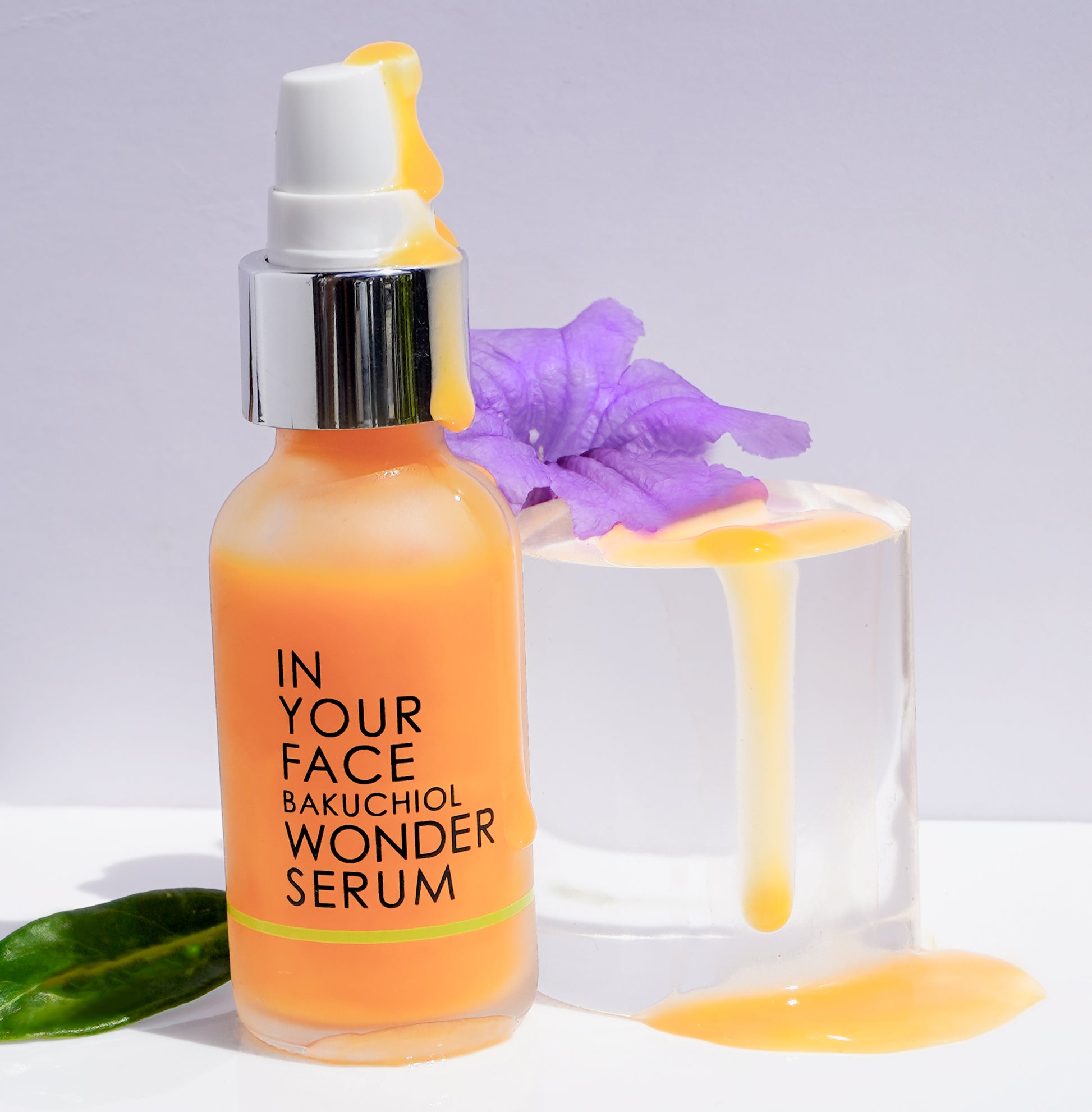 BAKUCHIOL WONDER SERUM with texture and purple flower.