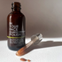 open bottle of the BAMBOO REFINING POLISH on white surface 