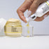 DEW IT BRIGHT DUO - woman's hand squeezing VITAMIN C PLUMPING SERUM onto acrylic block
