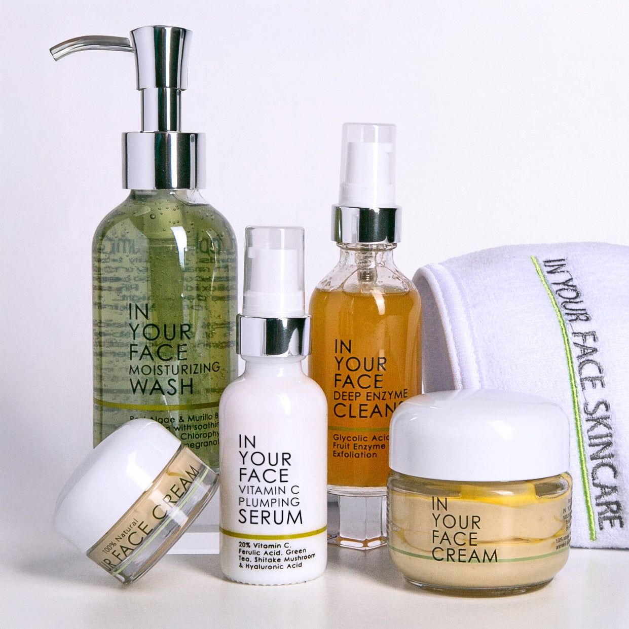 Collection of 'In Your Face' skincare products on a white background
