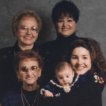 an image of Denice Duff holding her daughter beside her mother, grandmother, and great-grandmother