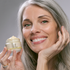 woman smiling and holding THE CREAM