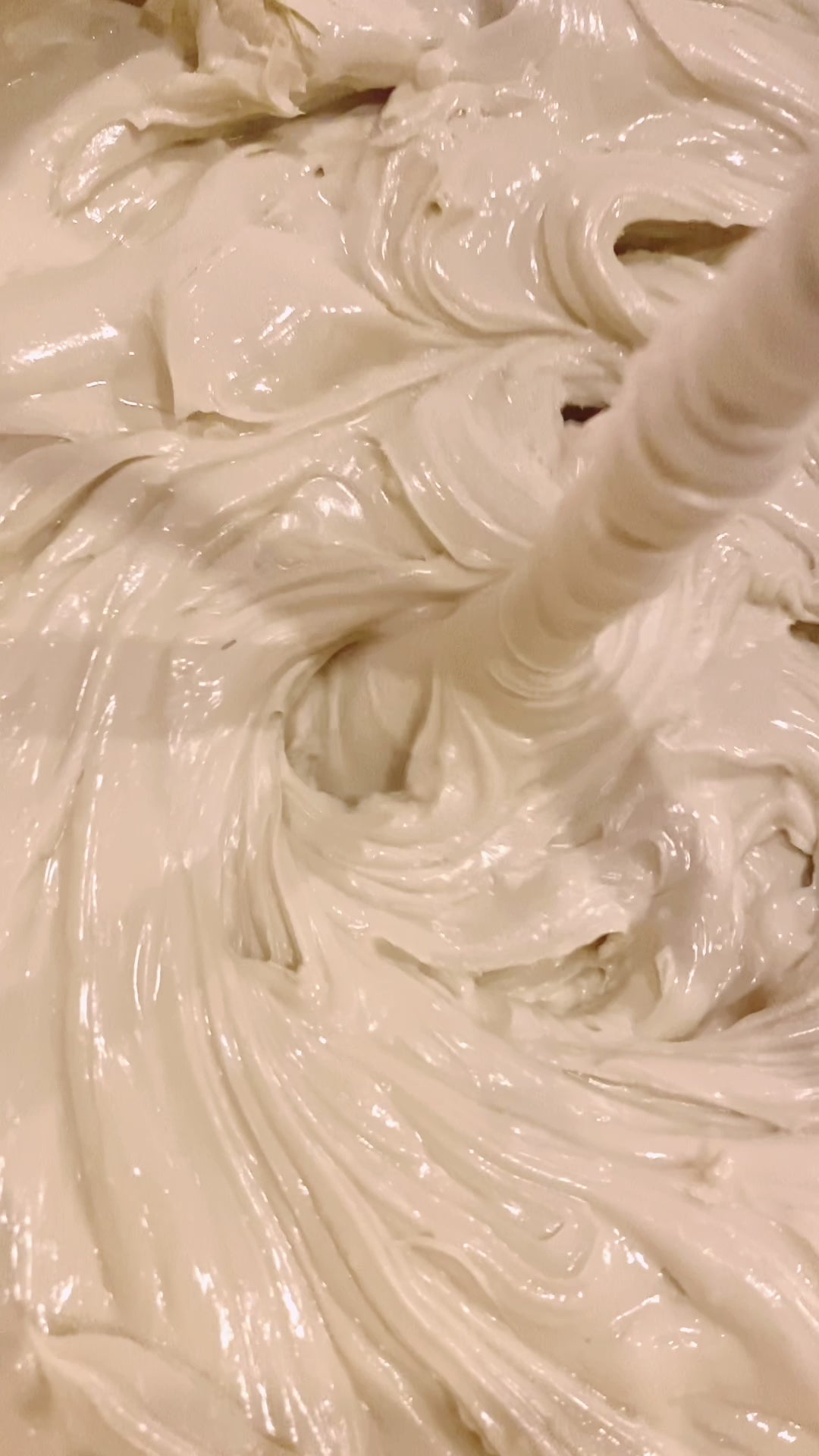 video of THE CREAM being blended - swirling in a bucket by a mixer blade