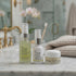 video of mini versions of 3 products: Moisturizing Wash, he Cream & Vitamin C Plumping Serum on a marble bathroom counter with a towel and brushed gold fixtures behind it.