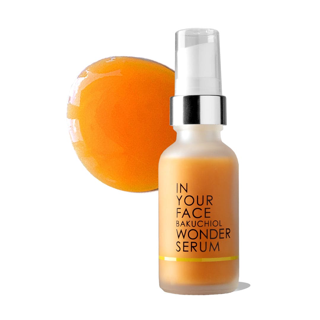 a bottle of the BAKUCHIOL WONDER SERUM, showing it being an orange color. It's on a white background and the bottle has a small shadow. The bottle has a pump dispenser. Next to the bottle is a dollop of the serum, showing it being a glowy orange color.
