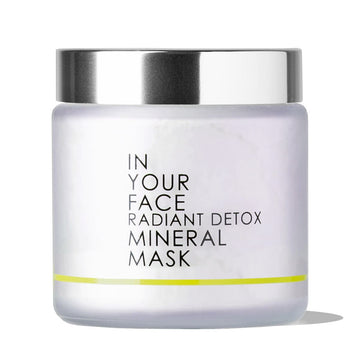 A clean photo of the IN YOUR FACE RADIANT DETOX MINERAL MASK on a white background. The inside of the jar (with a silver lid) looks to be a pale pink.