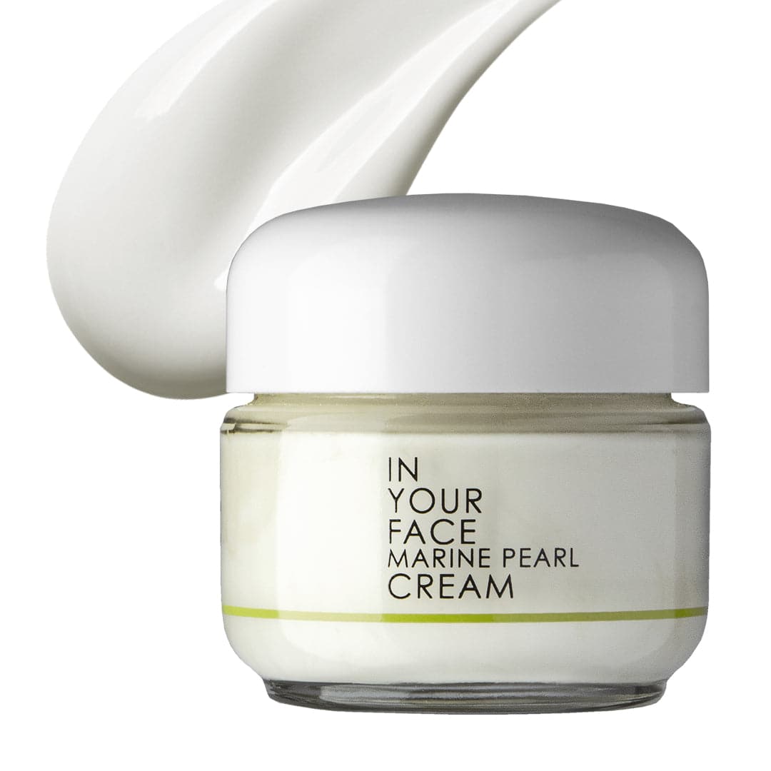 a clean image on a white background of IN YOUR FACE MARINE PEARL CREAM, with a small shadow under it. The cream looks like it is a soft very pale ivory color. It also shows a smear of the cream itself right next to the jar, which has a nice smooth-looking texture.