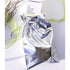 metallic gift bag holding THE CREAM inside