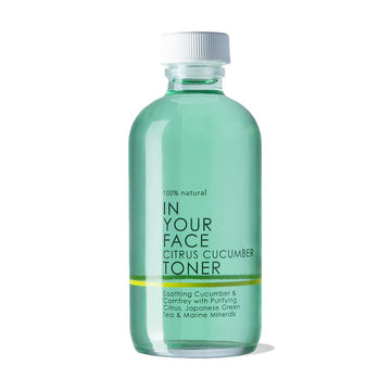 A bottle saying "100% Natural IN YOUR FACE CITRUS CUCUMBER TONER" on a white background. It is a pretty light aqua and in a clear bottle. The bottle also says "Soothing Cucumber & Comfrey with Purifying Citrus, Japanese Green Tea & Marine Minerals"