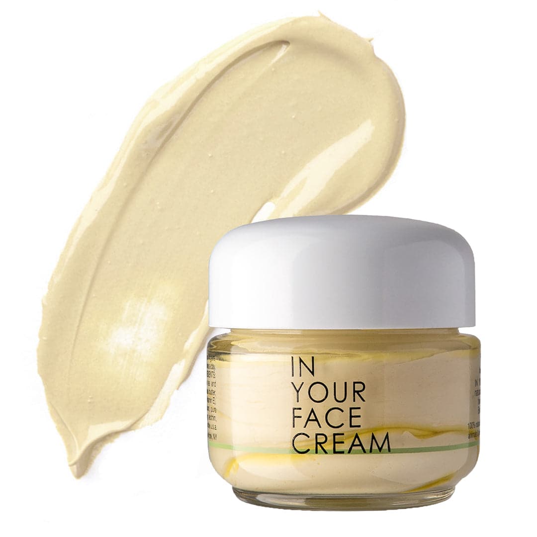 a jar of IN YOUR FACE CREAM on a plain white background, with a buttery yellow smear of the cream next to it.