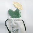 GUA SHA STONE peeking out of drawstring bag