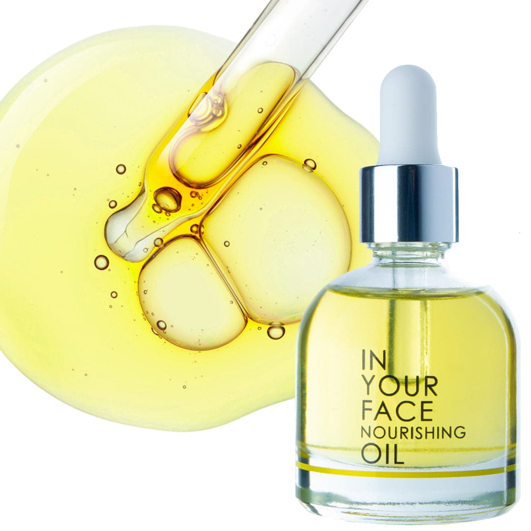 a clean image of the IN YOUR FACE NOURISHING OIL on a white background. The oil is in a clear bottle with a squeezable dropper inside. The oil is a beautiful clear golden color. Next to this image is an oil pipette in a circular drop of oil, with bubbles inside.